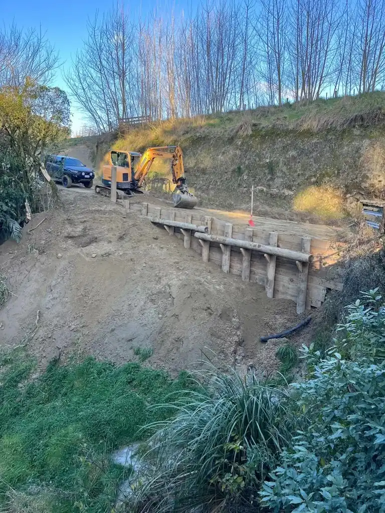 Bridge abutment under construction over a stream gully